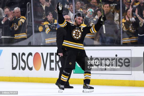 Patrice Bergeron of the Boston Bruins waves to fans before exiting the ice after Florida Panthers defeat the Bruins 4-3 in overtime of Game Seven of...