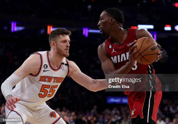 Isaiah Hartenstein of the New York Knicks tries to keep Bam Adebayo of the Miami Heat from moving the ball in the first half during game one of the...