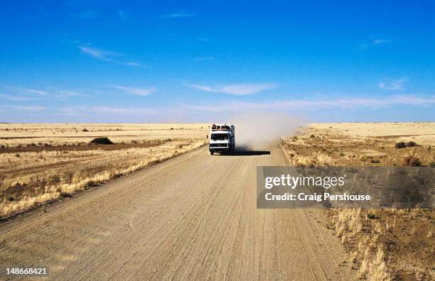 overland truck on dusty road  between noordwoewer and ai-ais. - horizon over land road stock pictures, royalty-free photos & images