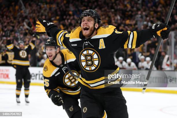 David Pastrnak of the Boston Bruins celebrates with Brandon Carlo after scoring a goal against the Florida Panthers during the third period in Game...