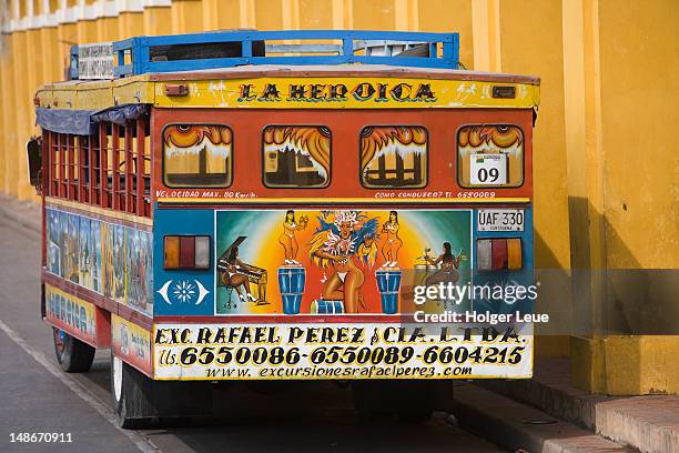 traditional colombian chiva bus in front of las bovedas. - cartagena colombia stock illustrations