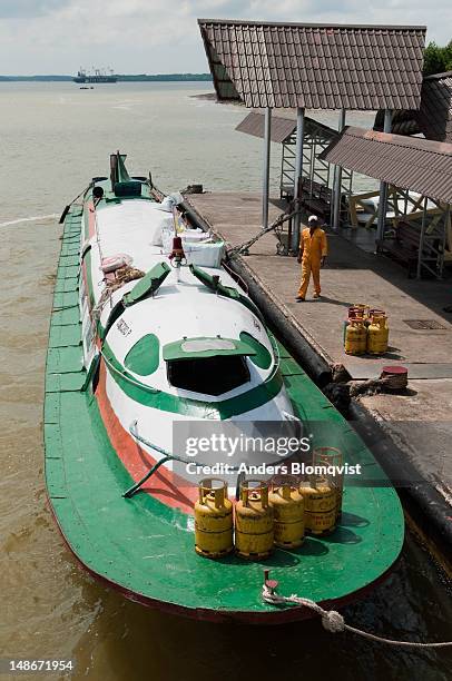 cigar-shaped passengerboat on waters of lower batang rejang near sibu. - sibu river stock pictures, royalty-free photos & images