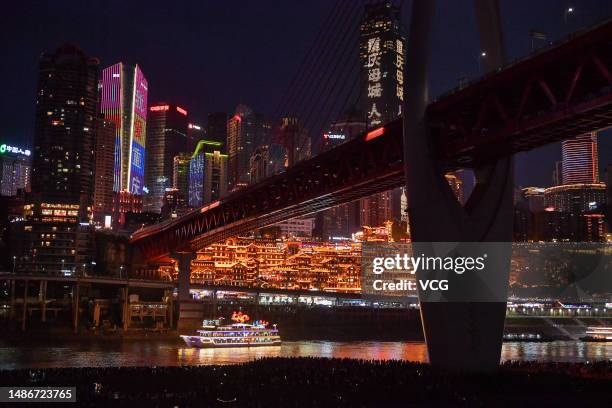 Tourists enjoy the night view of Hongya Cave during the May Day holiday on April 30, 2023 in Chongqing, China.