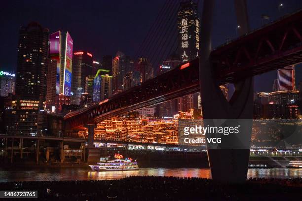 Tourists enjoy the night view of Hongya Cave during the May Day holiday on April 30, 2023 in Chongqing, China.