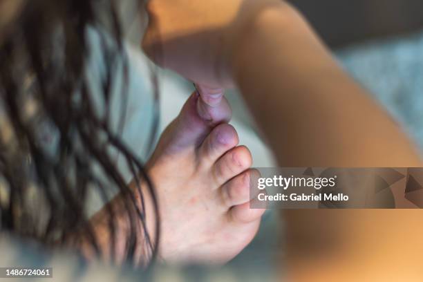 woman taking care of man's ingrown nail - zehennagel stock-fotos und bilder