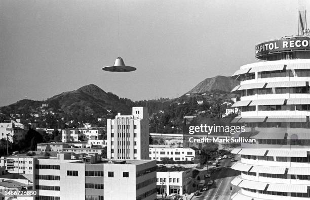 Prop flying saucer is suspended under an unseen helicopter during production of a Television Commercial for Ringo Starr's Goodnight Vienna album at...