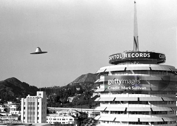 Prop flying saucer is suspended under an unseen helicopter during production of a Television Commercial for Ringo Starr's Goodnight Vienna album at...