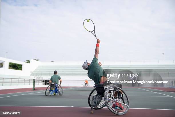 disabled athlete wheelchair tennis training before the competition. - wheelchair tennis stock pictures, royalty-free photos & images