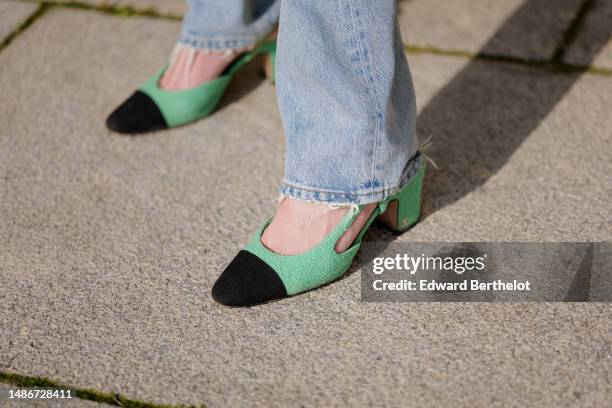 Natalia Verza wears pale blue denim large pants from Agolde, green tweed with black velvet toe-cap / block heels ballerinas from Chanel, during a...