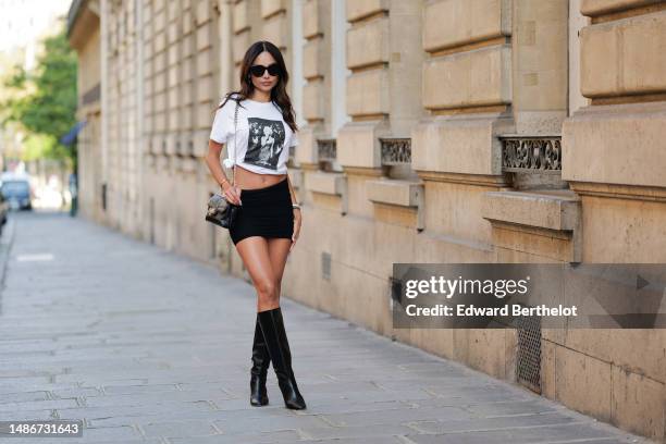 Patricia Gloria Contreras wears black large sunglasses from Fendi, silver and white pendant logo earrings from Van Cleef and Arpels, a white with...