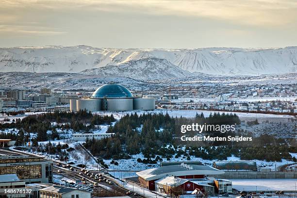 overview of reykjavik and perlan complex from hallgrims church (hallgrimskirkja). - reykjavik hallgrimskirkja stock pictures, royalty-free photos & images