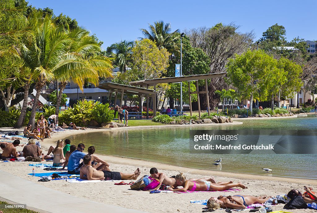 People relaxing at the Airlie Beach swimming lagoon.