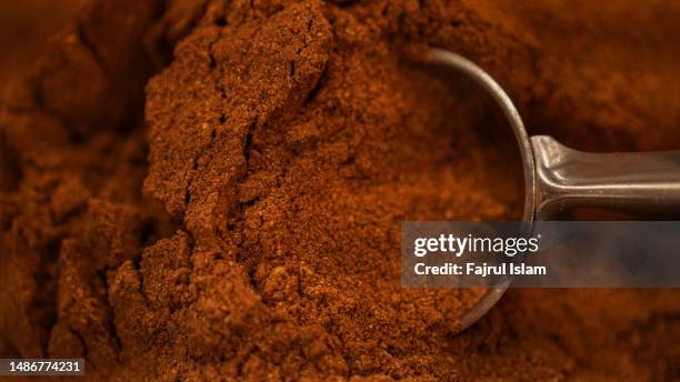 ground cinnamon on rustic background - cinnamon stock pictures, royalty-free photos & images