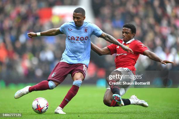 Ashley Young of Aston Villa is tackled by Tyrell Malacia of Manchester United during the Premier League match between Manchester United and Aston...