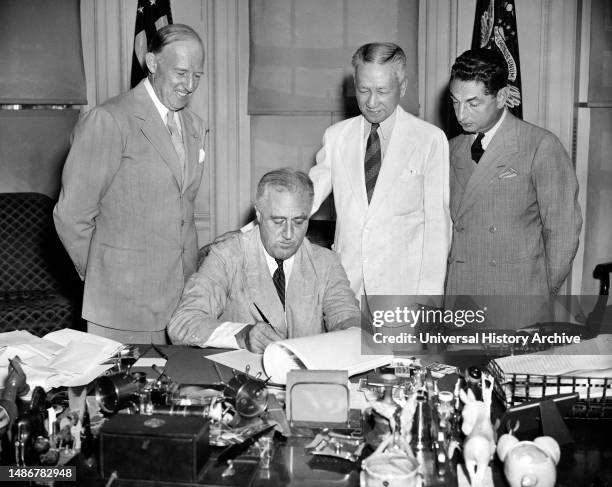 President Franklin Roosevelt signing bill that facilitated economic adjustment of Philippine Commonwealth to independence status, Washington, D.C.,...