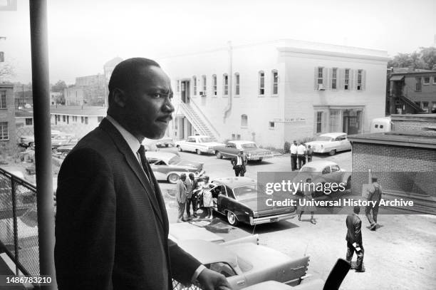 Martin Luther King standing on balcony at A. G. Gaston Motel overlooking parking lot, during Birmingham Campaign, Birmingham, Alabama, USA, Marion S....