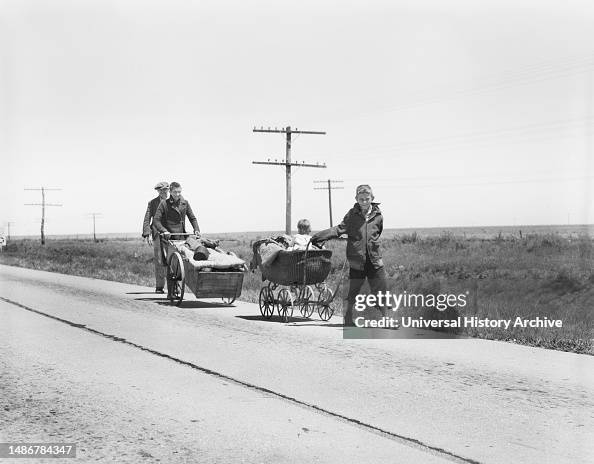 Flood refugees walking along Road four miles out of Memphis, Texas, USA, Dorothea Lange, U.S. Farm Security Administration, June 1937