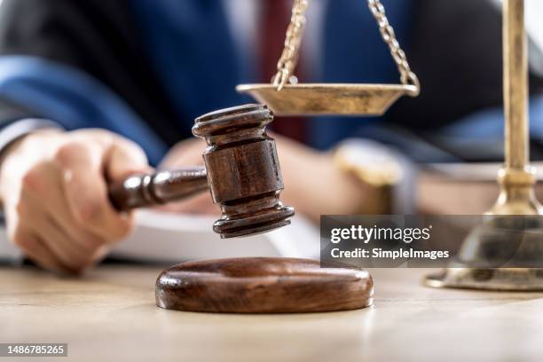 symbols of law a legal system - a judge, gavel and scales representing jurisdiction. - schuldspruch stock-fotos und bilder