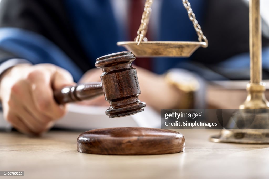 Symbols of law a legal system - a judge, gavel and scales representing jurisdiction.