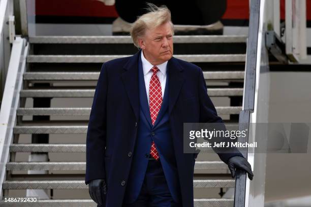 Former U.S. President Donald Trump disembarks his plane "Trump Force One" at Aberdeen Airport on May 1, 2023 in Aberdeen, Scotland. Former U.S....