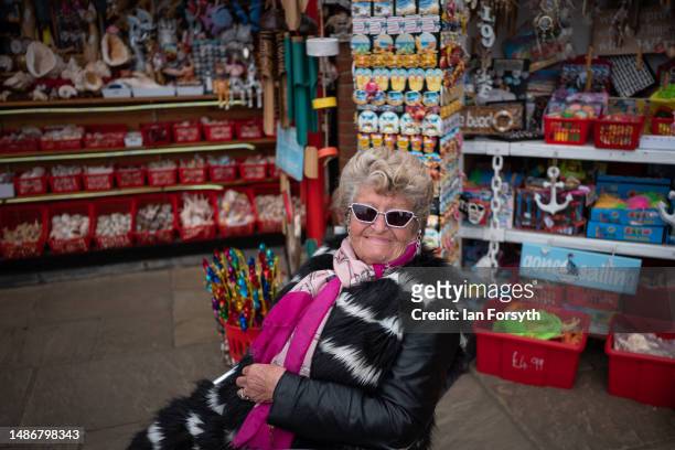 Rita Smith, who's family own a number of shops on the seafront poses for a picture as people visit Scarborough on May Day bank holiday on May 01,...