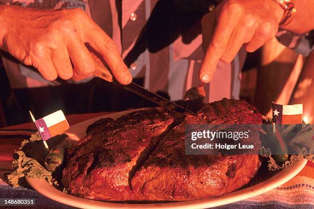 person cutting four-pound steak, big texan steak ranch. - amarillo color stock-fotos und bilder