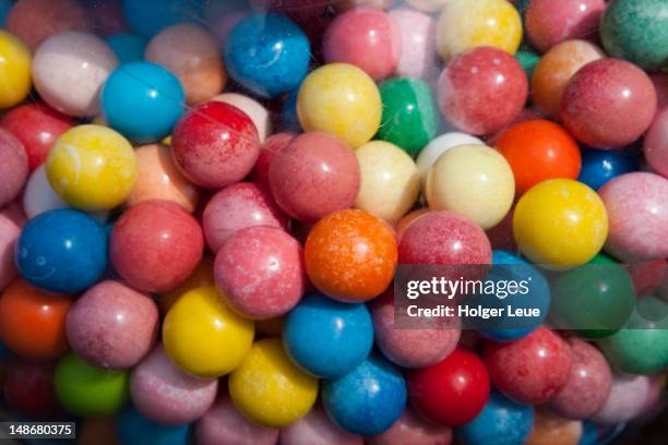 colourful bubble gum balls inside machine. - bubble gum stock pictures, royalty-free photos & images