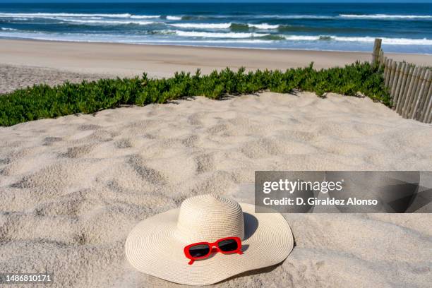 hat and sunglasses on the sandy beach, space for text. summer vacation concept - straw hat stock pictures, royalty-free photos & images