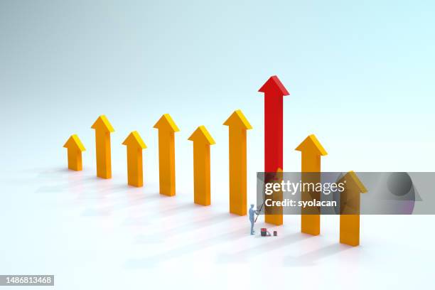 yellow financial arrow symbols are painted to the red color - syolacan stock pictures, royalty-free photos & images