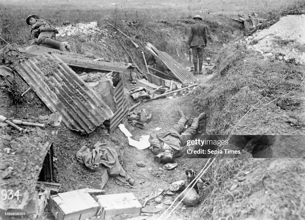 Captured World War I German machine gun position, Grevillers, France, A German machine gun position photographed just after its capture by New Zealand troops during World War I. Shows a New Zealander inspecting the trench in which a dead German soldier la