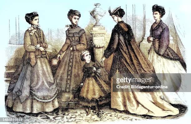 Four women and two girls in current spring fashion, costumes and ready-to-wear by Madame Mary-Moison, shawls for dresses from Malle des Indes stores,...