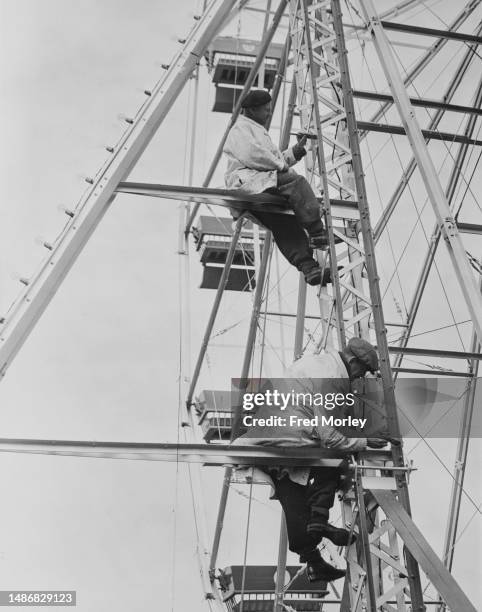 Painters RA Morley and RL Farrow painting the 'Big Wheel' at Dreamland, an amusement park in Margate, Kent, England, 16th April 1953. The park is...