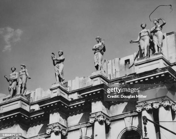 Close-up view of statuary lining the top of the Balham Hippodrome on Balham Hill in Balham, London, England, 11th April 1951. Designed by architect...