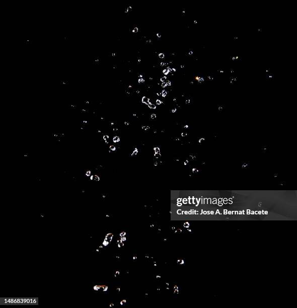 drops and splashes of water in motion on a black background. - bubble stock pictures, royalty-free photos & images