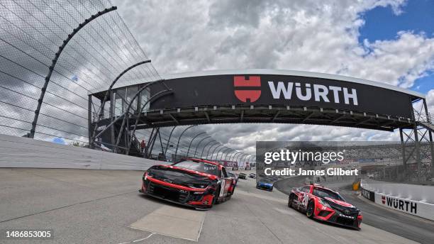 Kyle Busch, driver of the Lenovo Chevrolet, and Christopher Bell, driver of the Rheem Toyota, lead the field on a pace lap prior to the NASCAR Cup...