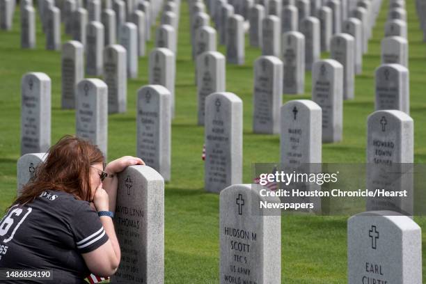 Elizabeth Thomas visits the grave of her husband, Army Staff Sgt. David Thomas, a veteran of Iraq and Afghanistan, as she honors him on Memorial Day...