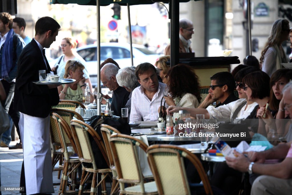 Waiter and diners at Les Deux Magots cafe in St-Germain-des-Pres.