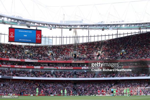 General view of the inside of the stadium as the LED Screen displays the message 'Potential Penalty Check VAR' as players of Arsenal and VfL...
