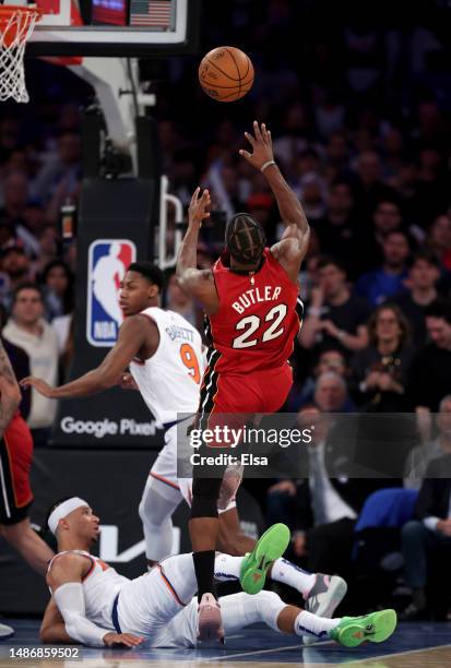 Jimmy Butler of the Miami Heat sprains his ankle on this play as he goes up for a shot and Josh Hart of the New York Knicks defends during game one...
