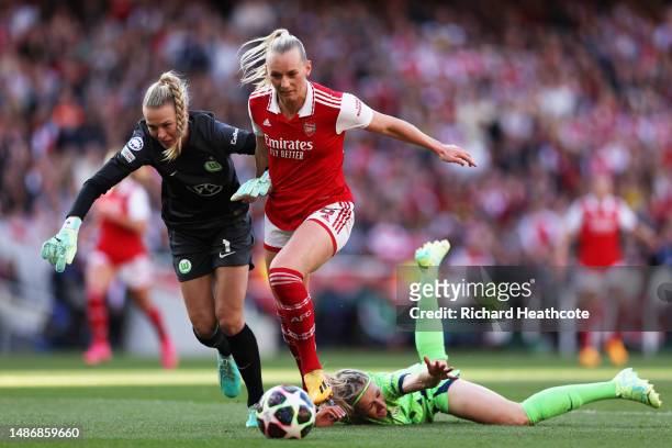 Stina Blackstenius of Arsenal is challenged by Merle Frohms and Kathrin Hendrich of VfL Wolfsburg, before going on to score the teams first goal,...