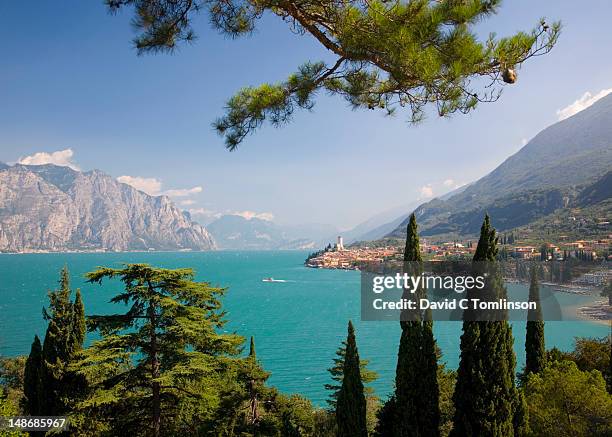 outlook to village of malcesine across turquoise waters of lake garda. - malcesine stock pictures, royalty-free photos & images