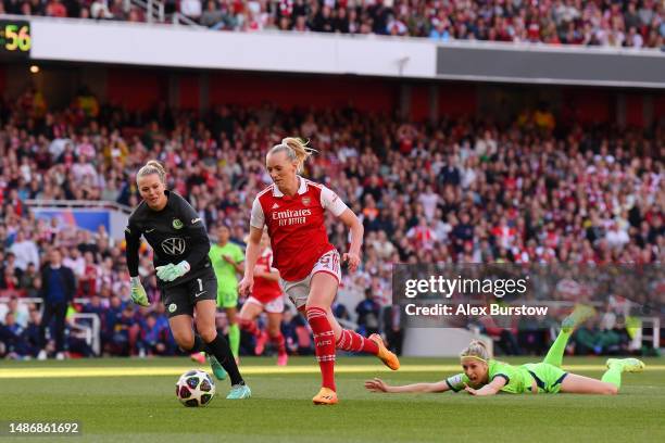 Stina Blackstenius of Arsenal scores the team's first goal as Merle Frohms and Kathrin Hendrich of VfL Wolfsburg looks on during the UEFA Women's...