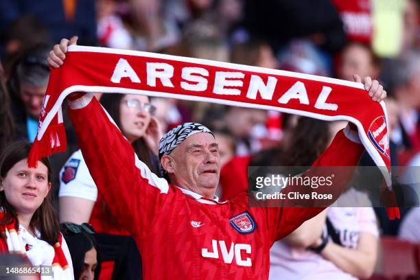 Fan of Arsenal, raises a scarf which reads "Arsenal", prior to the UEFA Women's Champions League semi-final 2nd leg match between Arsenal and VfL...