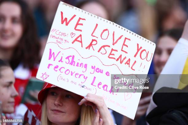Fan of Arsenal, holds a sign showing support of Leah Williamson of Arsenal which reads "Wishing You A Speedy Recovery Leah", during the UEFA Women's...