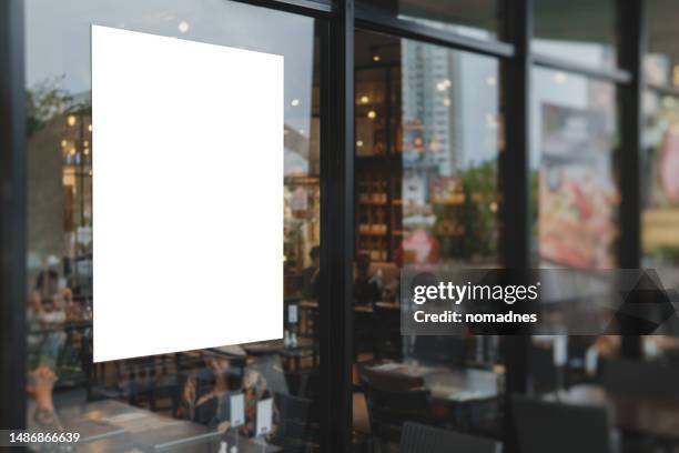 blank poster on window glass template. empty placard attached on window glass. billboard and various business promotions for retail stores and restaurants. - mockup vitrine photos et images de collection