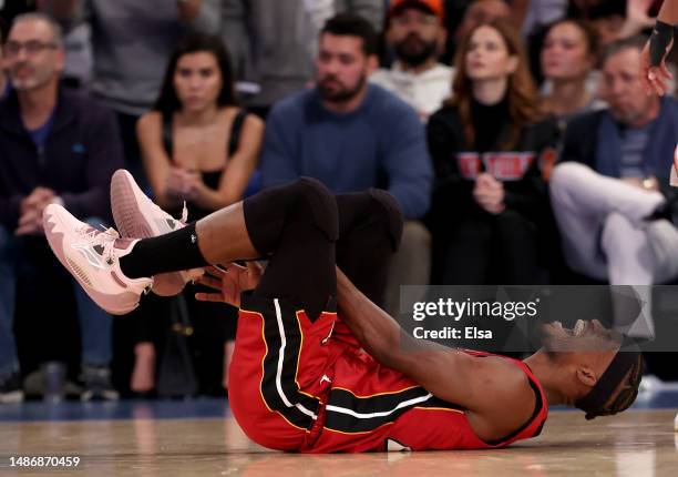 Jimmy Butler of the Miami Heat reacts after he falls in the third quarter against the New York Knicks during game one of the Eastern Conference...