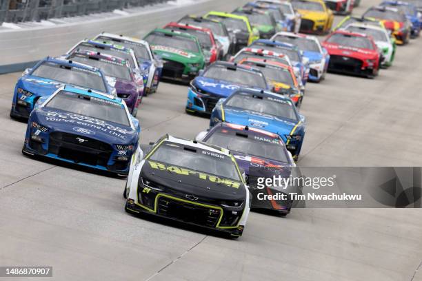 William Byron, driver of the RaptorTough.com Chevrolet, leads Denny Hamlin, driver of the FedEx Office Toyota, and Brad Keselowski, driver of the...