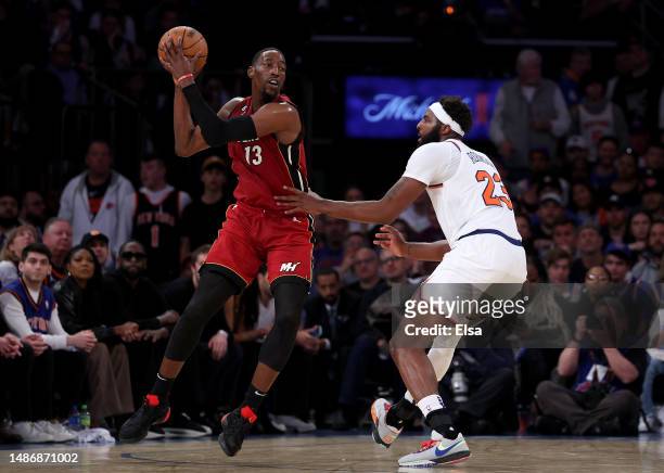 Bam Adebayo of the Miami Heat grabs the rebound as Mitchell Robinson of the New York Knicks defends during game one of the Eastern Conference...