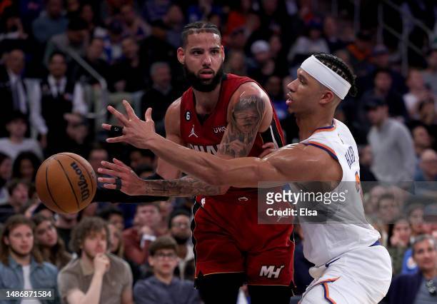 Caleb Martin of the Miami Heat tries to pass as Josh Hart of the New York Knicks defends during game one of the Eastern Conference Semifinals at...