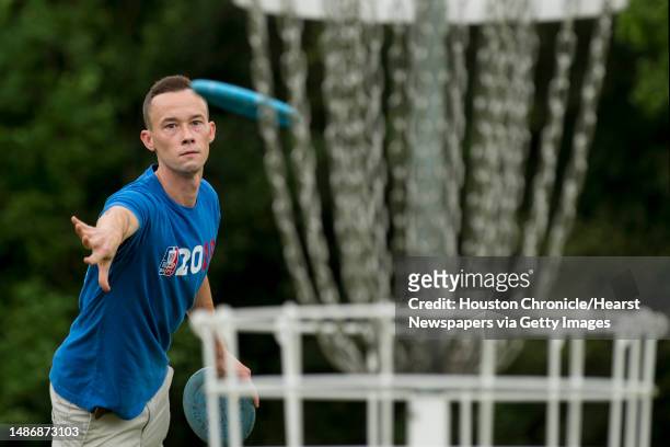 Shea Cain takes a shot while playing a round of disc golf during the Thursday night league of the Houston Flying Disc Society on Thursday, Sept. 3,...